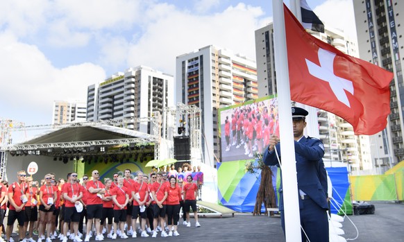 The swiss flag is raised up in front of the Swiss delegation during the welcome ceremony of the Team Switzerland in the Olympic Media Village in Rio de Janeiro, Brazil, prior to the Rio 2016 Olympic S ...