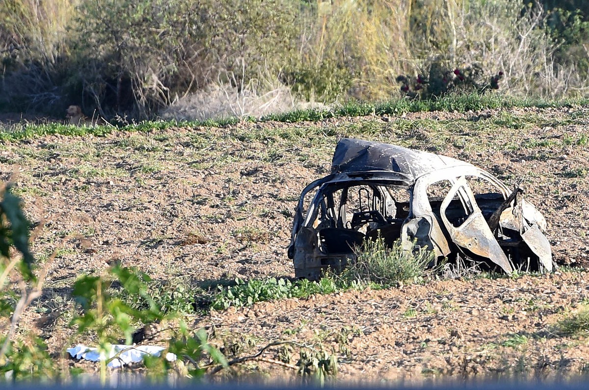 The wreckage of the car of investigative journalist Daphne Caruana Galizia lies next to a road in the town of Mosta, Malta, Monday, Oct. 16, 2017. Malta's prime minister says a car bomb has kille ...