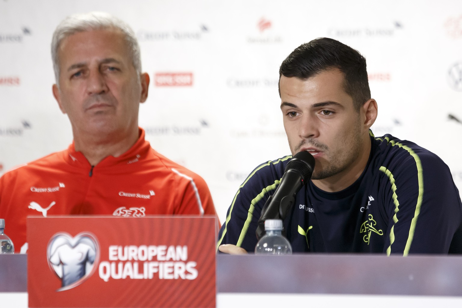 Switzerland&#039;s midfielder Granit Xhaka, left, sitting next to Switzerland&#039;s head coach Vladimir Petkovic speaks to the media during a press conference, ahead the UEFA Euro 2020 qualifying Gro ...