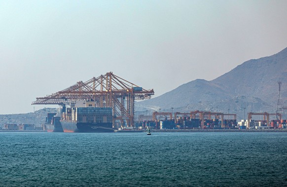 epa13095211 A container ship docks at Khor Fakkan Port, in Khor Fakkan, United Arab Emirates, 07 July 2026. As one of the upcoming measures for the UAE to avoid sending its shipping vessels through th ...