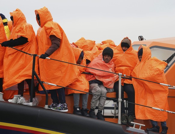 A group of people thought to be migrants travel on a vessel after being rescued by the RNLI following a small boat incident in the Channel, in Dungeness, Kent, England, Friday, Dec. 9, 2022. (Gareth F ...