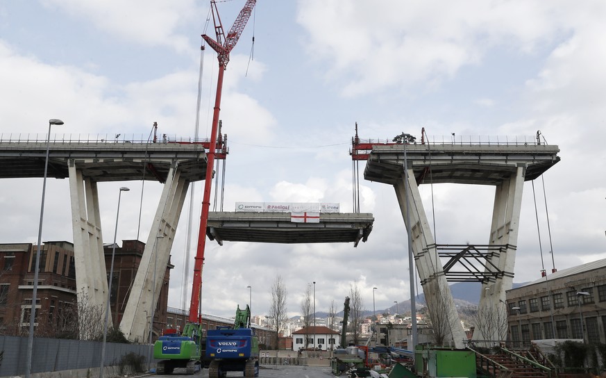 A view of of the Morandi bridge in Genoa, Italy, Saturday, Feb. 9, 2019. Workers taking apart the remains of a bridge which collapsed in Aug. 2018 are set to remove a 40 meter beam, seen in between th ...