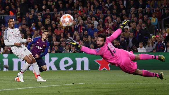 Liverpool goalkeeper Alisson dives to stop a shot by Barcelona's Philippe Coutinho, second left, during the Champions League semifinal first leg soccer match between FC Barcelona and Liverpool at the  ...