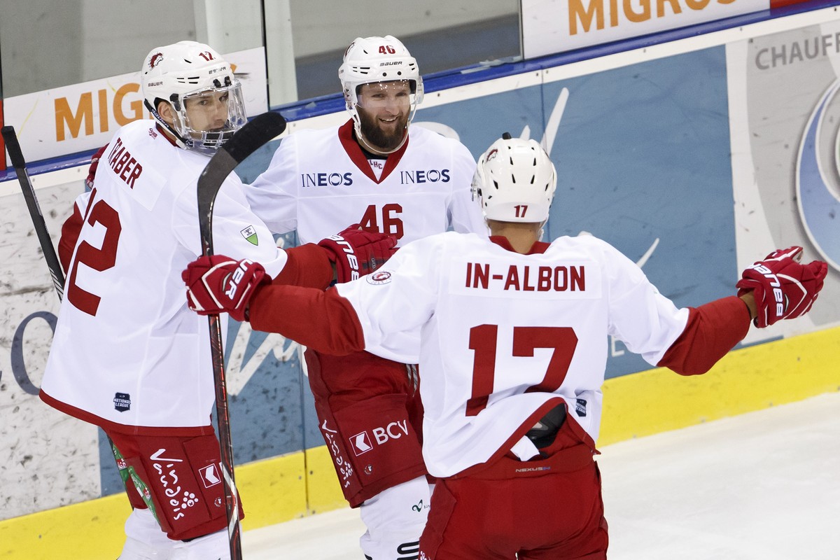 Lausanne's forward Benjamin Antonietti #46, celebrates his goal with teammates forward Tim Traber, left, and center Loic In-Albon, right after scoring the 1:1, during a National League regular se ...