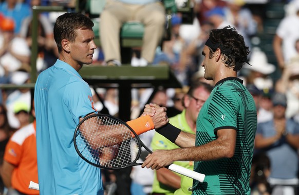 Roger Federer, right, of Switzerland, and Tomas Berdych, of the Czech Republic, shake hands after Federer defeated Berdych 6-2, 3-6, 7-6 (6) during a tennis match at the Miami Open, Thursday, March 30 ...