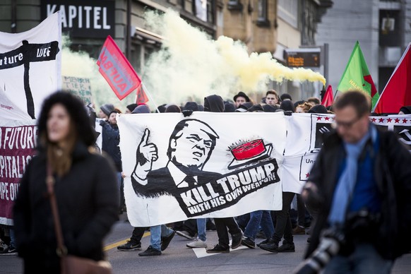 epa06436051 Protesters demonstrate against the World Economic Forum (WEF) and US president Donald Trump, in Bern, Switzerland, 13 January 2018. The WEF will take place from January 23 till January 26  ...