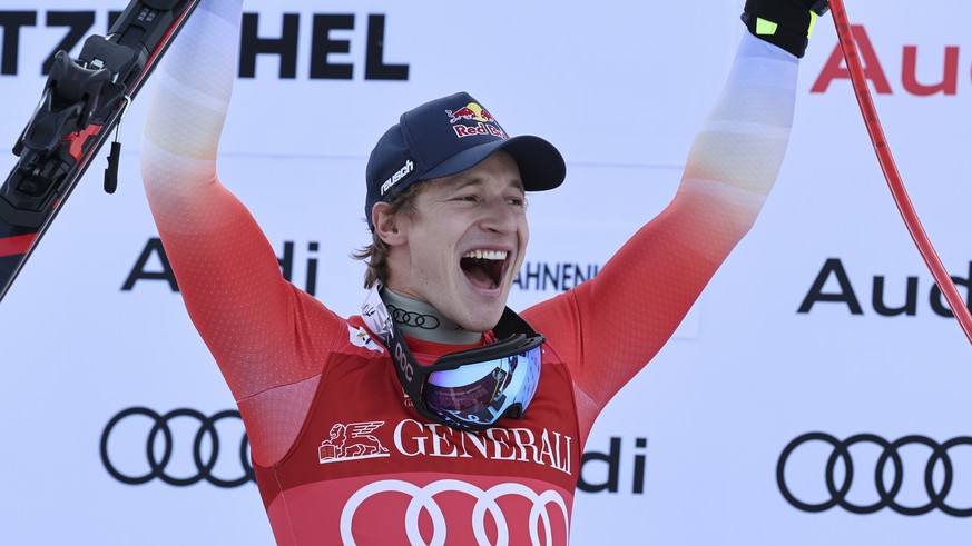 Switzerland&#039;s Marco Odermatt celebrates on the podium after winning an alpine ski, men&#039;s World Cup Super-G, in Kitzbuehel, Austria, Friday, Jan. 24, 2025. (AP Photo/Marco Trovati)