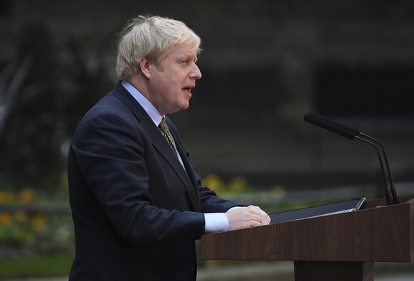 Britain's Prime Minister Boris Johnson waves on the steps after speaking outside 10 Downing Street in London on Friday, Dec. 13, 2019. Boris Johnson's gamble on early elections paid off as voters gave ...