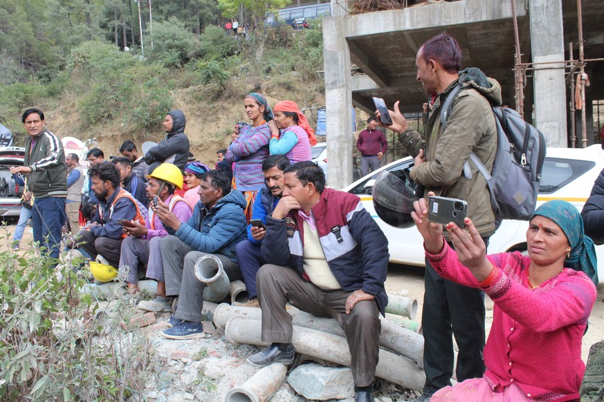 People watch rescue operations at the site of an under-construction road tunnel that collapsed in Silkyara in the northern Indian state of Uttarakhand, India, Tuesday, Nov. 29, 2023. Officials in Indi ...
