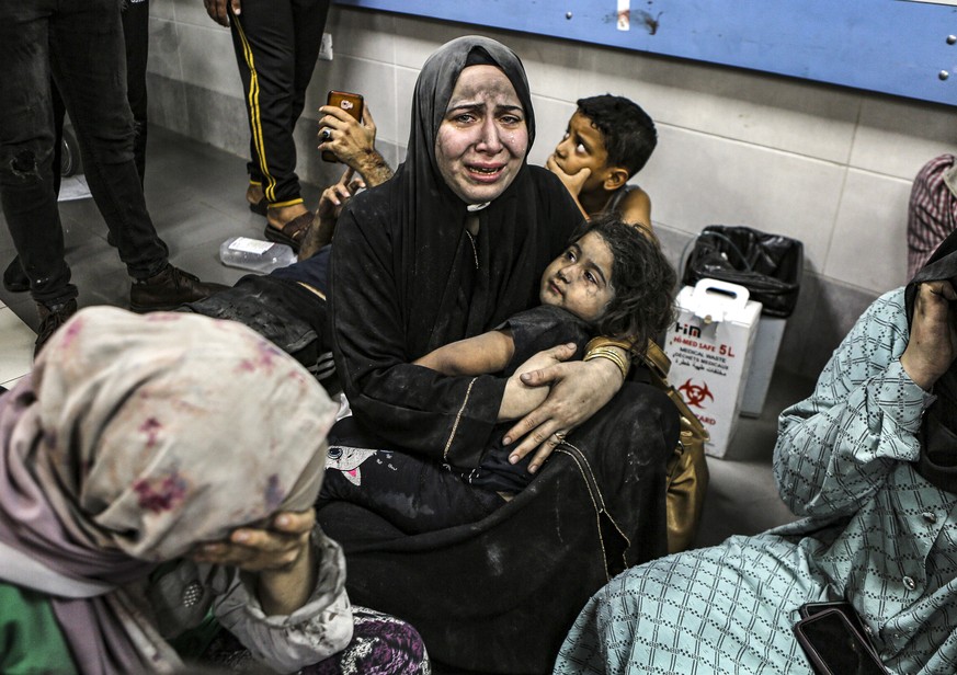 Wounded Palestinians lay at the al-Shifa hospital, following Israeli airstrikes, in Gaza City, central Gaza Strip, Tuesday, Oct. 17, 2023. (AP Photo/Abed Khaled)