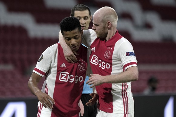 Ajax's David Neres, right, celebrates hid goal with his teammate Davy Klaassen, scored a first goal, during the Europa League round of 32 second leg soccer match between Ajax and Lille at the Johan Cr ...