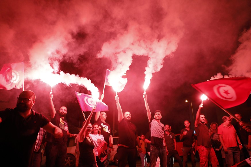 epa07845692 Supporters of Tunisia&#039;s jailed presidential candidate Nabil Karoui celebrate in front of his headquarters as results come in, in Tunis, Tunisia on 15 September 2019. The first round o ...