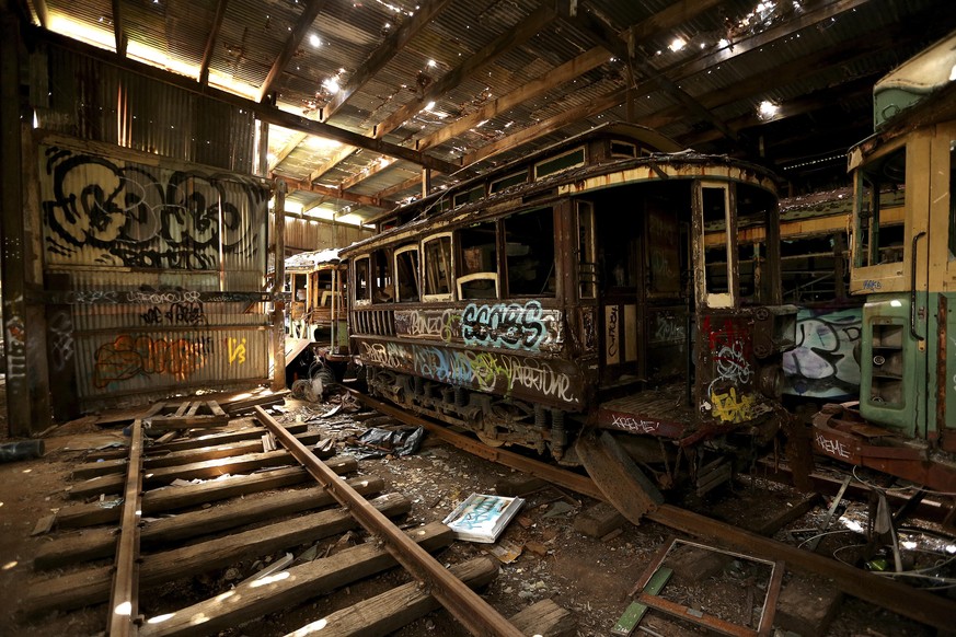 In this Oct. 22, 2014 photo, old tramcars and trolley buses sit abandoned and wrecked in the Loftus Tram Shed in Sydney. Trams became a key part of life in Sydney after the network was installed in 18 ...