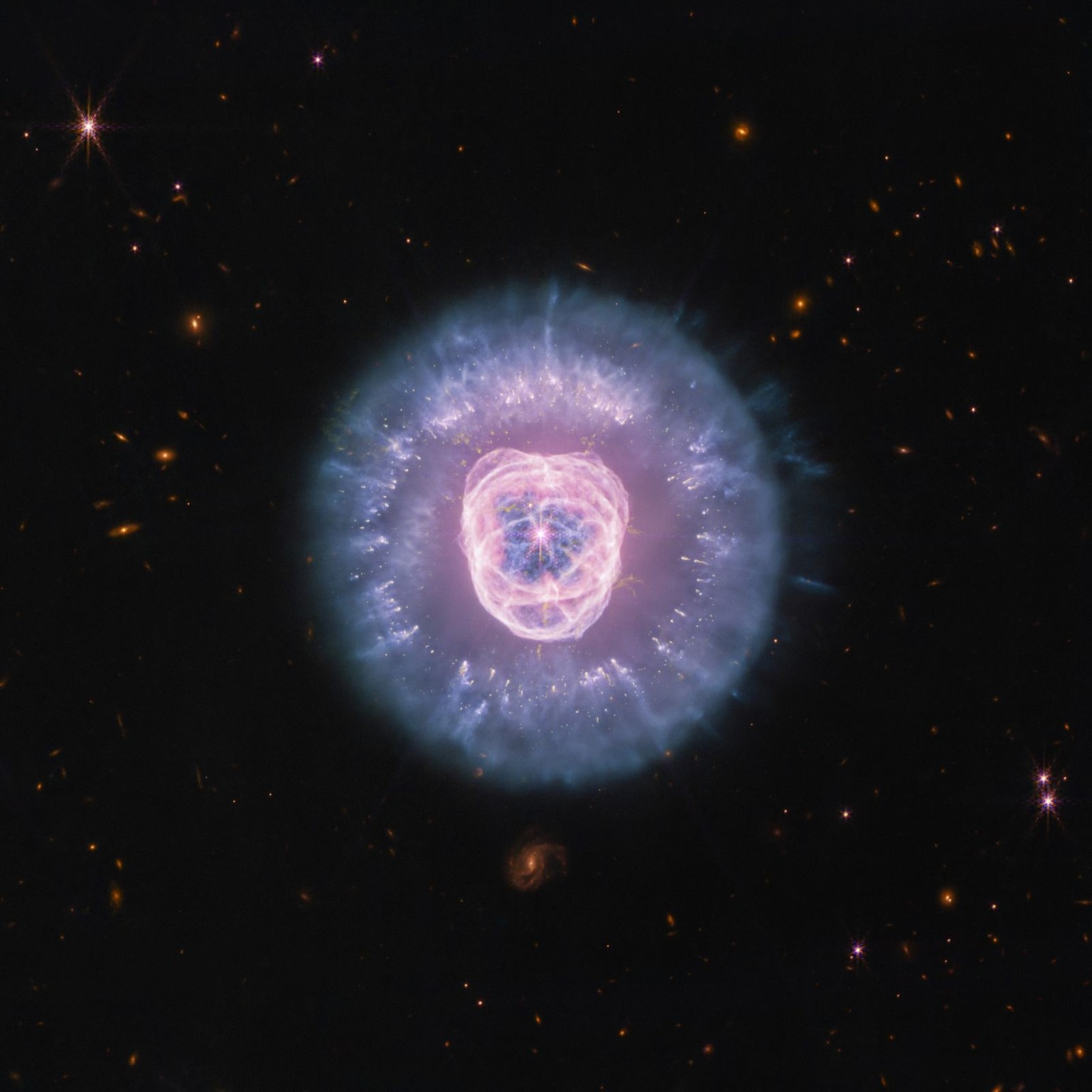 The James Webb Space Telescope recently imaged planetary nebula NGC 2392, which is nicknamed the Lion Nebula due to its distinct shape. This near- and mid-infrared composite image reveals the complex  ...