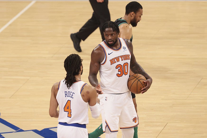 New York Knicks forward Julius Randle (30) celebrates with guard Derrick Rose (4) after an NBA basketball game against the Boston Celtics in New York, Sunday, May 16, 2021. (Vincent Carchietta/Pool Ph ...