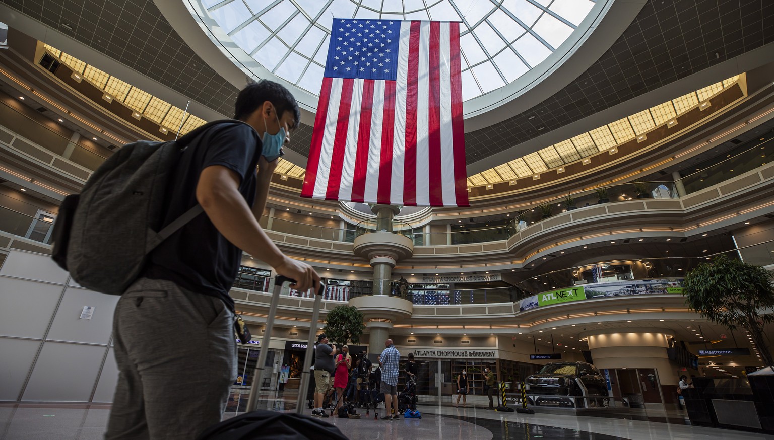 epa08523634 A passenger walks through the main domestic terminal ahead of the Fourth of July holiday travel weekend at Hartsfield-Jackson Atlanta International Airport in Atlanta, Georgia, USA, 02 Jul ...