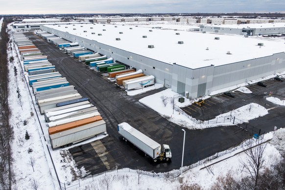 epa08982848 An aerial photo made with a drone shows an Amazon warehouse in Waukegan, Illinois, USA, 02 February 2021. Amazon CEO Jeff Bezos has announced that he will leave his position in the summer  ...