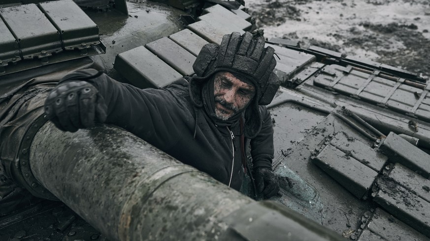 A Ukrainian soldier looks out of a captured Russian tank in the front line in Donetsk region, Ukraine, Tuesday, Nov. 22, 2022. (AP Photo/Libkos)