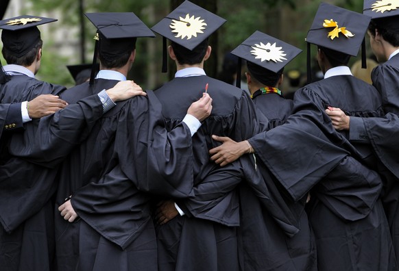 FILE - In this May 20, 2013 file photo, graduates pose for photographs during commencement at Yale University in New Haven, Conn. There&#039;s still plenty of pomp and circumstance, inspiring words fr ...