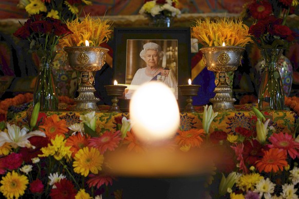 Butter lamp is lit at a Buddhist monastery during a prayer session to mark the funeral of Britain&#039;s Queen Elizabeth II in Kathmandu, Nepal, Monday, Sept. 19, 2022. (AP Photo/Niranjan Shrestha)