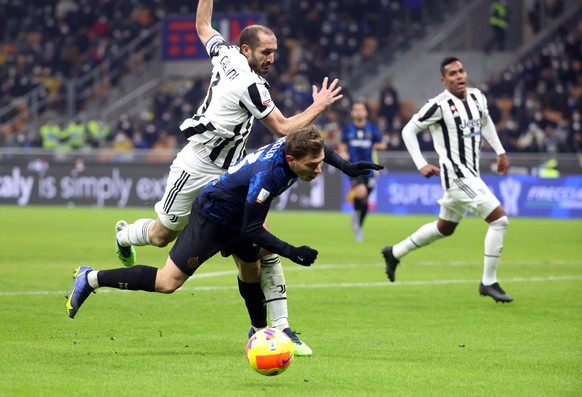 epa09681286 Juventus���s Giorgio Chiellini (L) and Inter Milan���s Nicolo Barella in action during the Italian Supercup match between FC Inter and Juventus FC at Giuseppe Meazza stadium in Milan, Ital ...