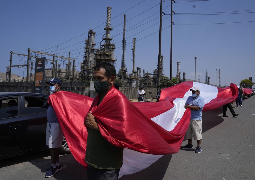 Artesanal fisherman protest outside the Repsol plant against an oil spill oil on Cavero beach in Ventanilla, Callao, Peru, Tuesday, Jan. 18, 2022, after high waves attributed to the eruption of an und ...