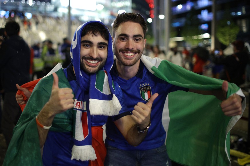 Italy supporters celebrate outside Wembley Stadium in London, Sunday, July 11, 2021, after Italy won the Euro 2020 soccer championship final match between England and Italy. (AP Photo/David Cliff)