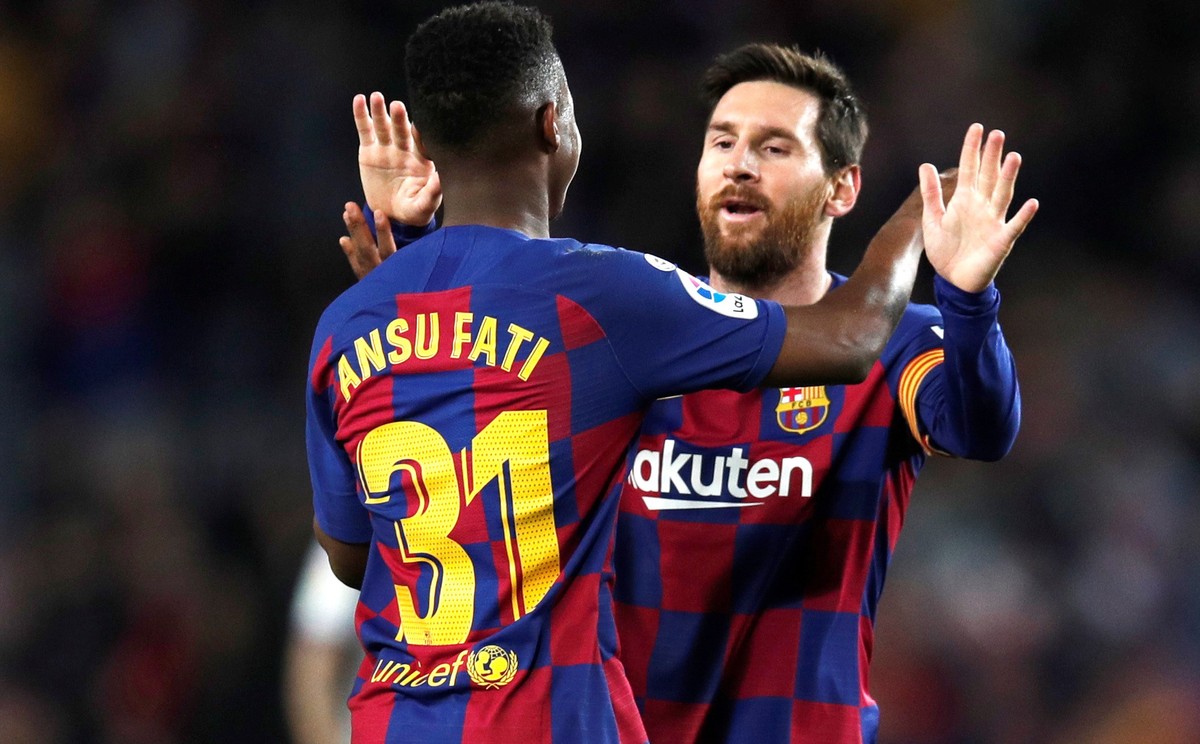 epa08188937 FC Barcelona's Ansu Fati (front) celebrates with teammate Lionel Messi after scoring during the Spanish LaLiga soccer match between FC Barcelona and UD Levante played at the Camp Nou  ...