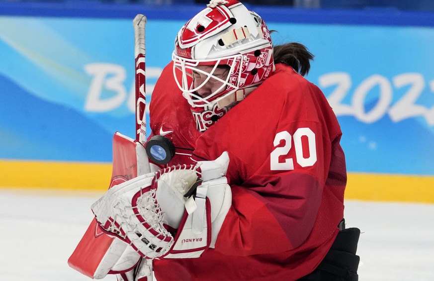 Switzerland goalkeeper Andrea Braendli (20) blocks a shot against the United States during a preliminary round women&#039;s hockey game at the 2022 Winter Olympics, Sunday, Feb. 6, 2022, in Beijing. ( ...