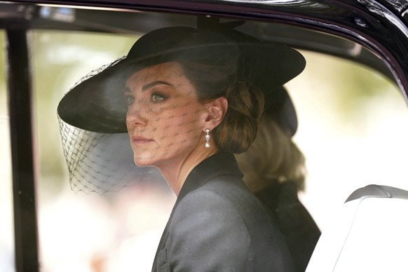 Kate, Princess of Wales, and Camilla, the Queen Consort, behind, follow the State Gun Carriage carrying the coffin of Queen Elizabeth II in the Ceremonial Procession following her State Funeral at Wes ...