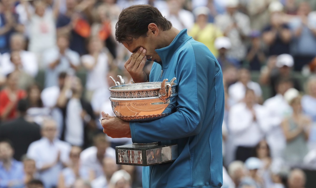 Spain's Rafael Nadal holds the trophy as he celebrates winning the men's final match of the French Open tennis tournament against Austria's Dominic Thiem in three sets 6-4, 6-3, 6-2, at ...