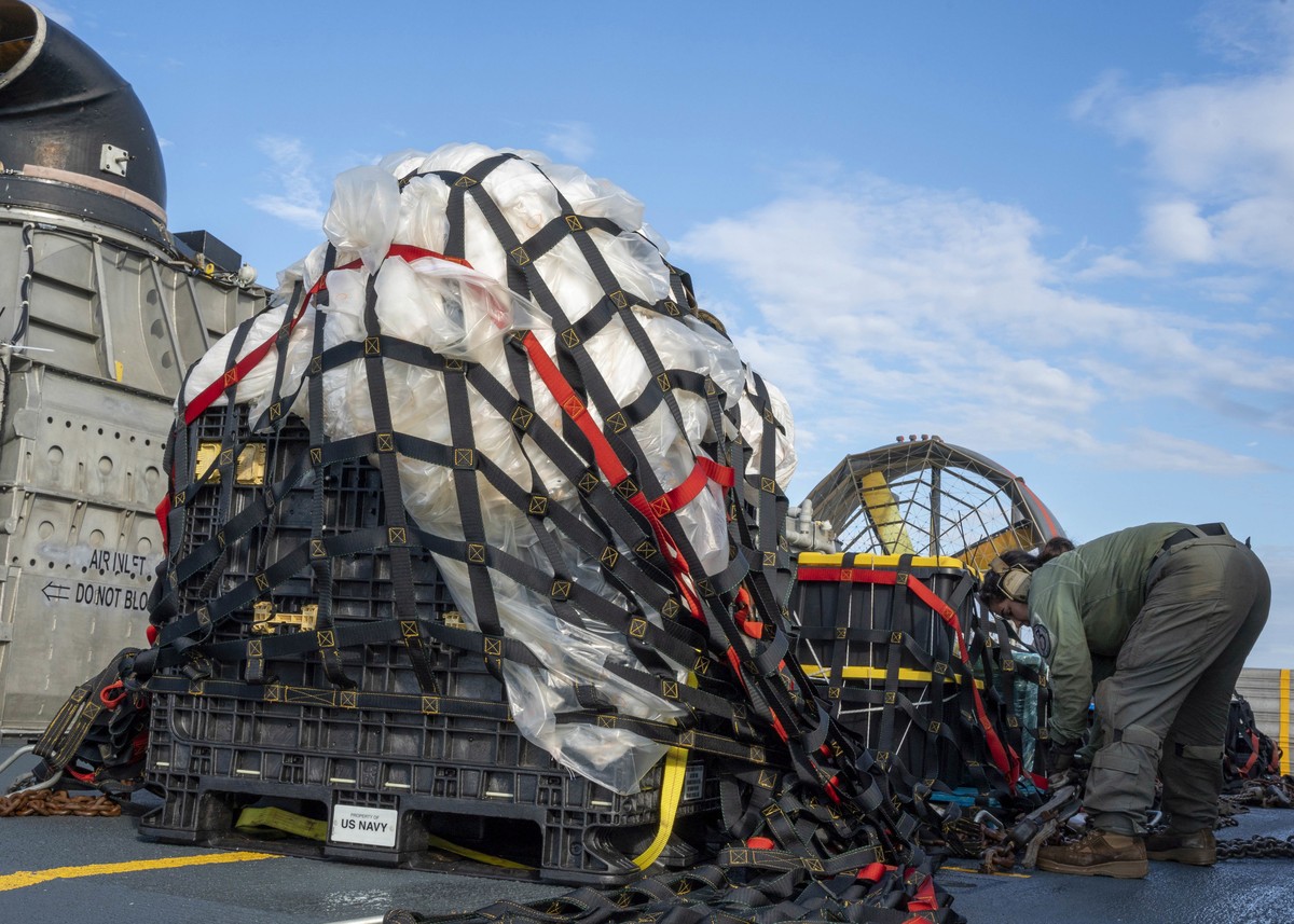 epa10466110 A handout photo made available by the US Navy shows a sailor assigned to Assault Craft Unit 4 preparing material recovered in the Atlantic Ocean from a high-altitude balloon for transport  ...