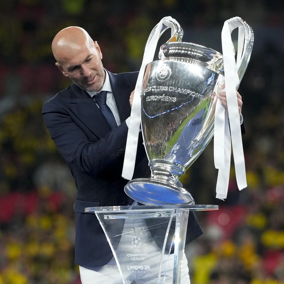 Zinedine Zidane handles the trophy after the Champions League final soccer match between Borussia Dortmund and Real Madrid at Wembley stadium in London, Saturday, June 1, 2024. (AP Photo/Kirsty Wiggle ...