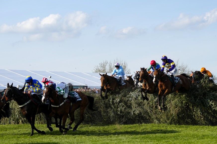 Derek Fox on Corach Rambler, right, clears the Chair fence to win the Grand National horse race at Aintree Racecourse Liverpool, England, Saturday, April 15, 2023. The iconic Grand National race which ...