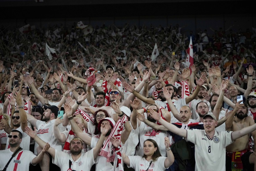 Georgia players celebrate at the end of a Group F match between Georgia and Portugal at the Euro 2024 soccer tournament in Gelsenkirchen, Germany, Wednesday, June 26, 2024. (AP Photo/Alessandra Tarant ...