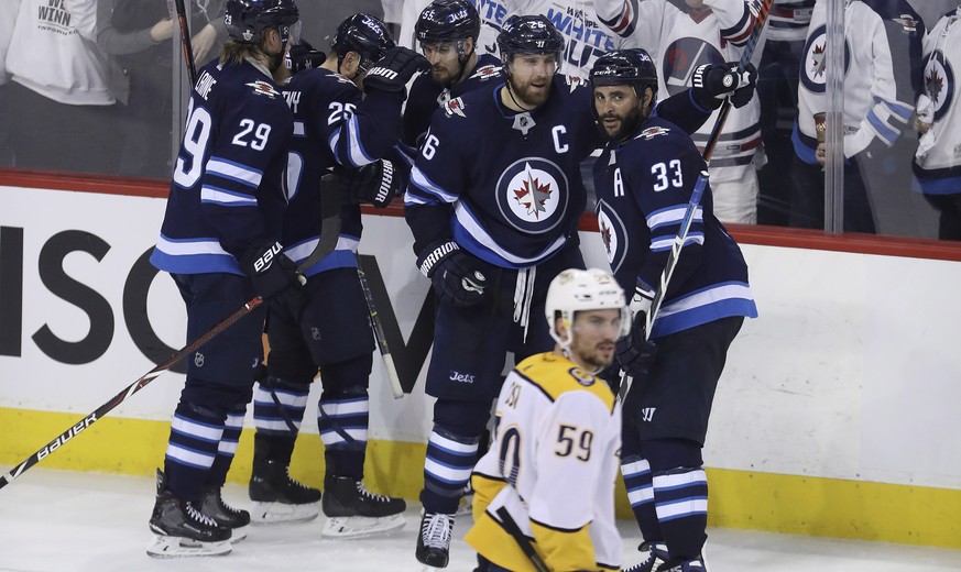 The Winnipeg Jets&#039; celebrate after Blake Wheeler (26) scored as Nashville Predators&#039; Roman Josi (59) looks on during third period NHL hockey playoff action in Winnipeg, Manitoba, Tuesday May ...