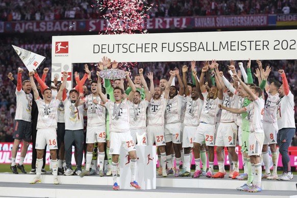 Bayern&#039;s Thomas Mueller, centre left, celebrates with the championship shield after the German Bundesliga soccer match between FC Bayern Munich and Borussia Moenchengladbach in Munich, Germany, S ...