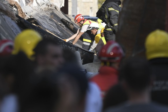 Rescue workers search for victims in the aftermath of an outdoor roof collapsed at a train station in Novi Sad, Serbia, Friday, Nov. 1, 2024. (AP Photo)