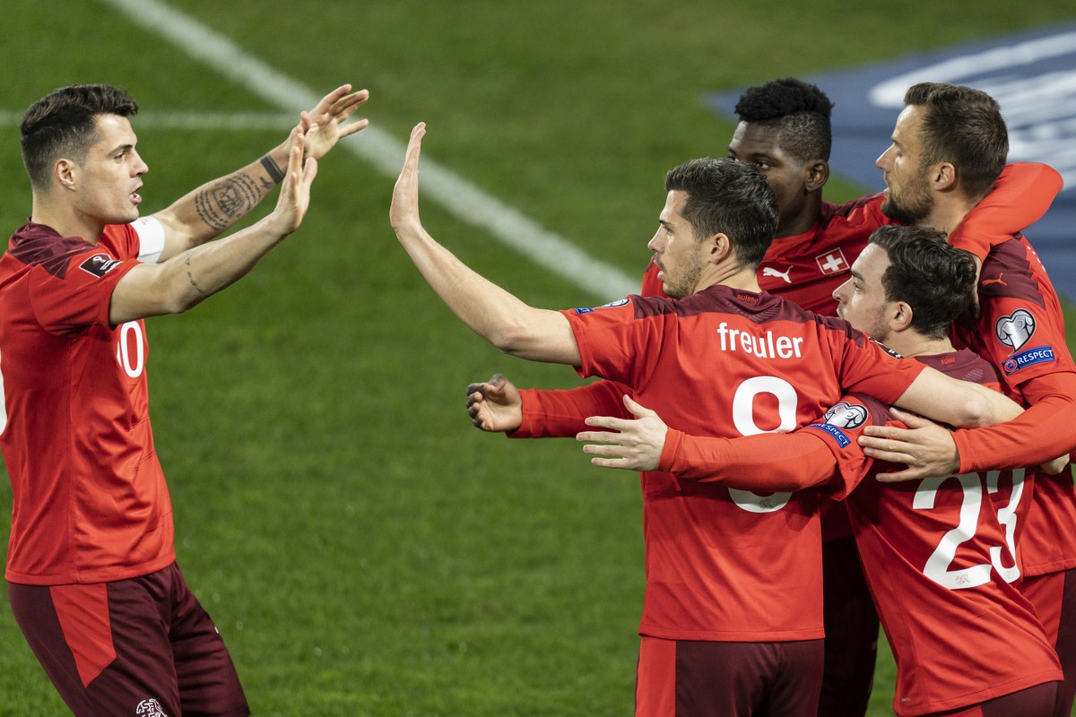 Swiss players Granit Xhaka, Remo Freuler, Breel Embolo and Haris Seferovic, from left, celebrate after Xherdan Shaqiri, 2nd right no 23, scored to 1:0 during the FIFA World Cup Qatar 2022 qualifying G ...