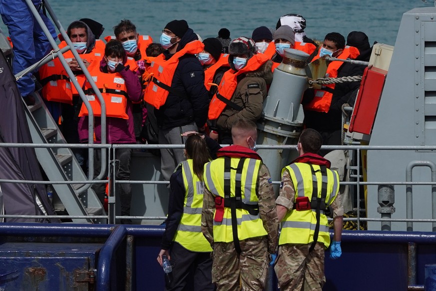 A group of people thought to be migrants are brought in to Dover, Kent, England, by the RNLI, following a small boat incident in the Channel, Thursday April 14, 2022. Britain&#039;s Conservative gover ...