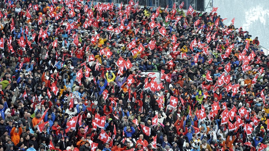 Supporters celebrate in the finish area after the first run in the men&#039;s ski world cup giant slalom in Adelboden, Switzerland, Saturday, January 9, 2010. The race was canceled due to bad weather  ...