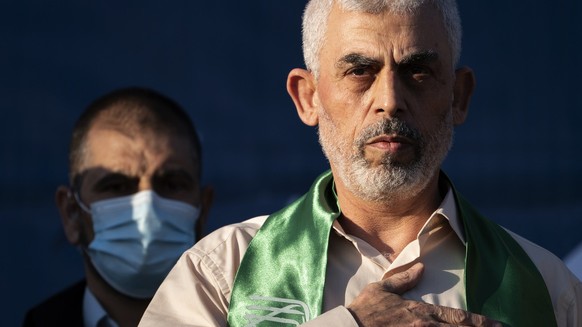 FILE - Yahya Sinwar, Palestinian leader of Hamas in the Gaza Strip, places his hand over his heart on stage after greeting supporters at a rally on May 24, 2021, in Gaza City, the Gaza Strip. (AP Phot ...