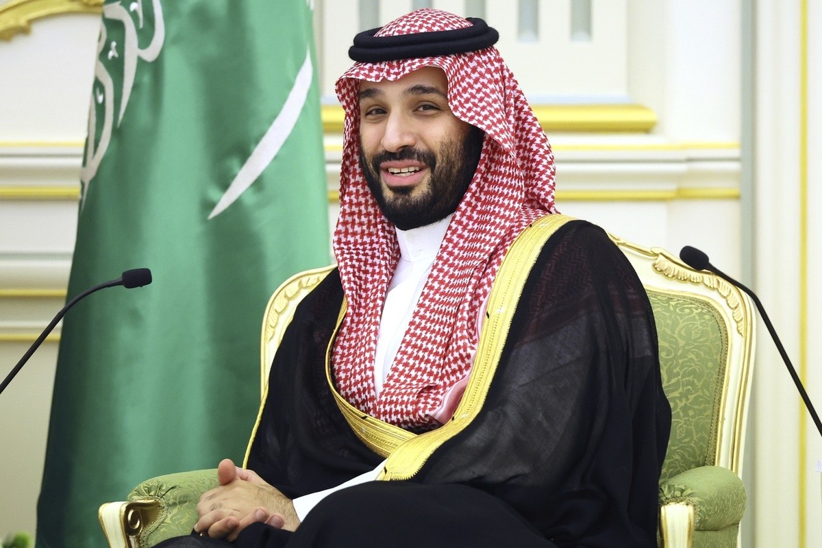 Saudi Crown Prince Mohammed bin Salman smiles as he listens to Russian President Vladimir Putin during their talks at the Al Yamamah Palace in Riyadh, Saudi Arabia, on Wednesday, Dec. 6, 2023. (Sergei ...