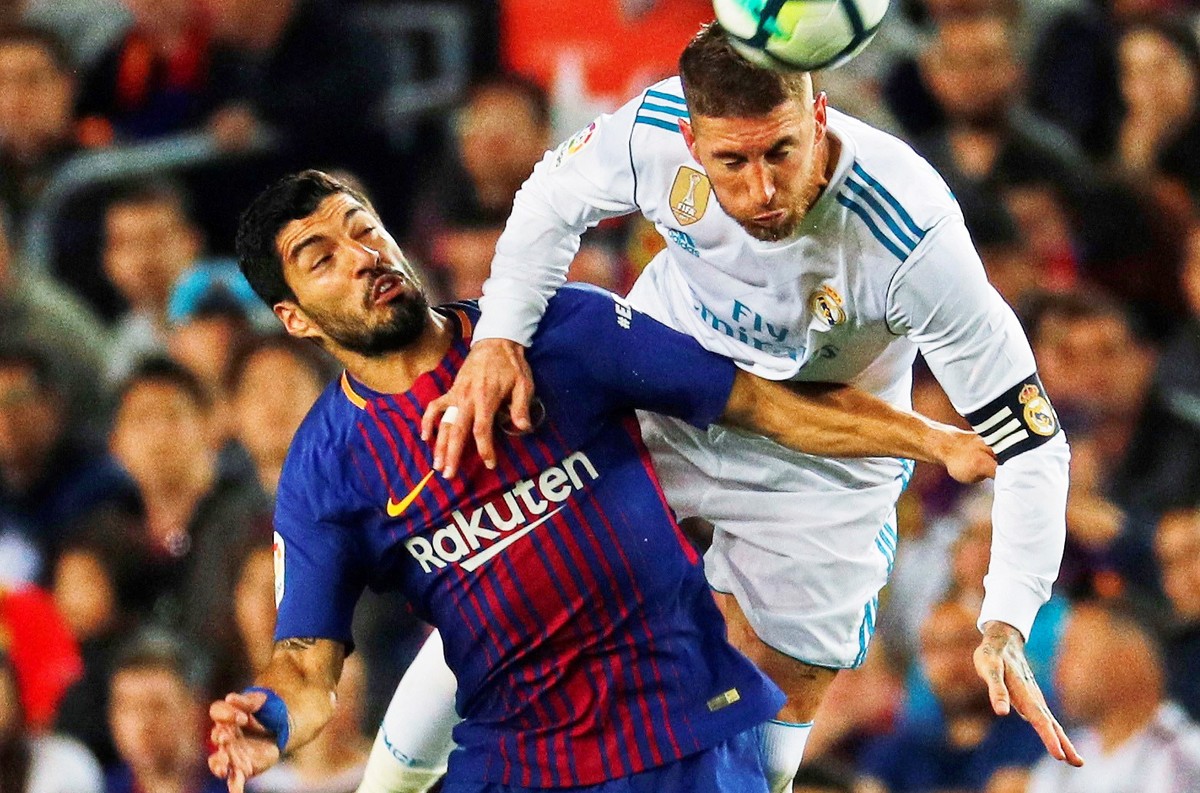 epa06715909 FC Barcelona's forward Luis Suarez (L) in action against Real Madrid's defender Sergio Ramos (R) during the Spanish Primera Division soccer match between FC Barcelona and Real Ma ...