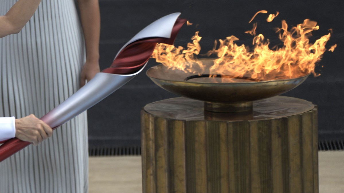 Greece's Olympic Cross Country Ski Champion Paraskevi Ladopoulou lights the flame during the Olympic flame handover ceremony at Panathinean stadium in Athens, Greece, Tuesday, Oct. 19, 2021. The  ...