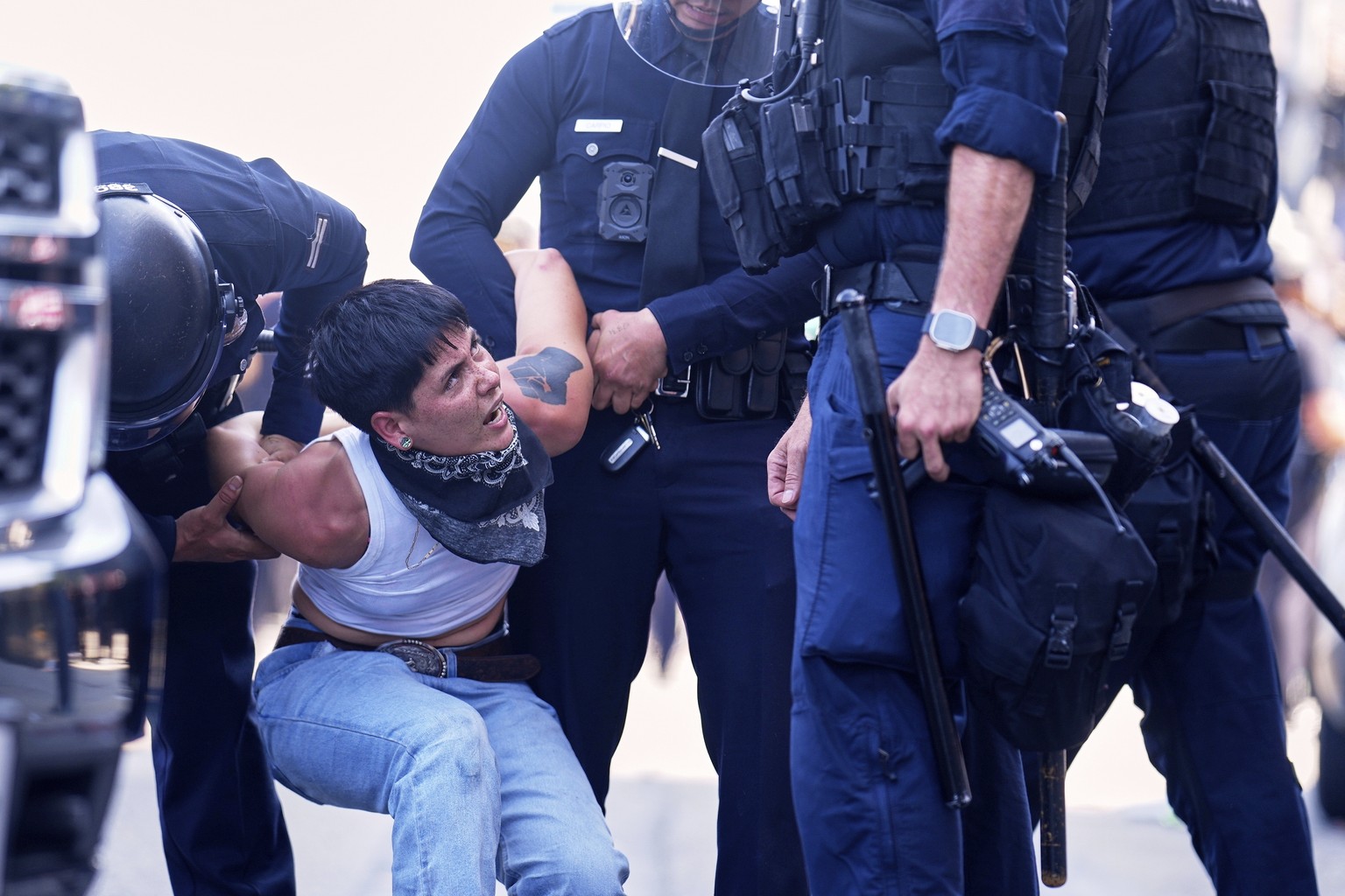 FILE - A protester is detained in downtown Los Angeles, Sunday, June 8, 2025, following last night&#039;s immigration raid protest. (AP Photo/Eric Thayer, File)
Immigration Raids Los Angeles Spotlight