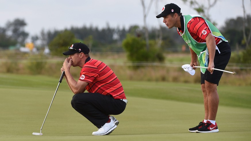 epa05473706 Graham Delaet of Canada lines up a putt in the first green in the round one of the Men&#039;s Individual stroke play at the Olympic golf course in the Rio 2016 Olympic Games in Rio de Jane ...