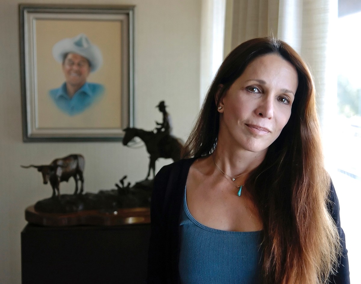 FILE - In this Nov. 20, 2004 file photo, Patti Davis, daughter of late U.S. president Ronald Reagan and Nancy Reagan, poses near artwork given to the resident at the Ronald Reagan Presidential Library ...