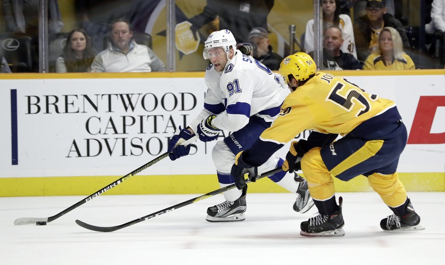 Tampa Bay Lightning center Steven Stamkos (91) moves the puck against Nashville Predators defenseman Roman Josi (59), of Switzerland, in the first period of an NHL hockey game Monday, Nov. 19, 2018, i ...