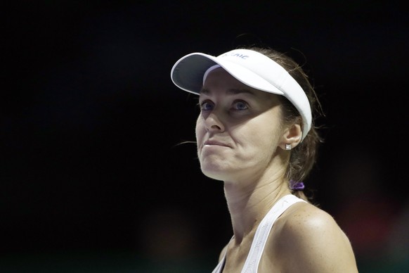 Martina Hingis of Switzerland, paired with partner Chan Yung-jan of Taiwan, reacts after conceding a point to Timea Babos of Hungary and Andrea Hlavackova of the Czech Republic during their doubles se ...